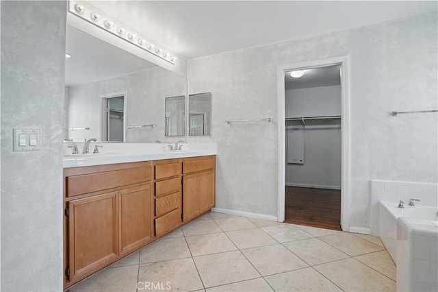 31868 Birchwood Dr, Lake Elsinore, CA 92532 - bathroom with tile patterned floors, double vanity, a walk in closet, and a garden tub