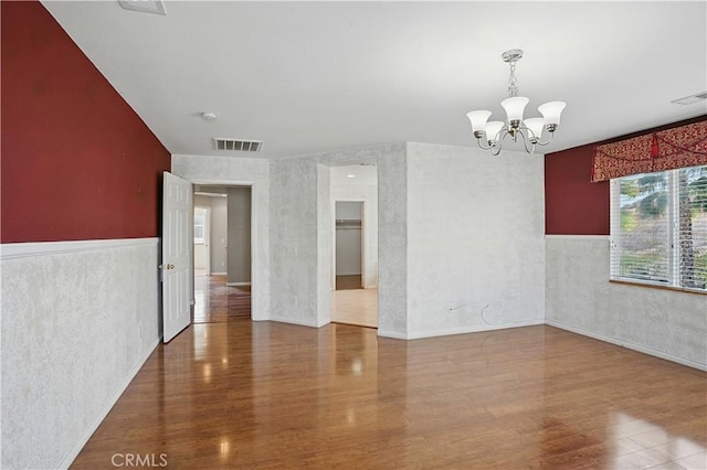 31868 Birchwood Dr, Lake Elsinore, CA 92532 - spare room featuring a chandelier, wood finished floors, a wainscoted wall, and a smoke detector