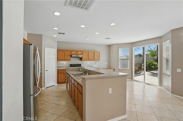 31868 Birchwood Dr, Lake Elsinore, CA 92532 - kitchen featuring freestanding refrigerator, recessed lighting, an island with sink, light tile patterned floors, and under cabinet range hood