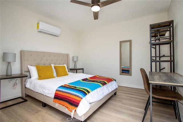 4574 Avenida Del Sol, Joshua Tree, CA 92252 - bedroom featuring a wall mounted air conditioner, wood finished floors, and a ceiling fan