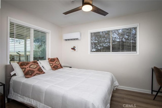 4574 Avenida Del Sol, Joshua Tree, CA 92252 - bedroom featuring a wall mounted air conditioner, wood finished floors, and a ceiling fan