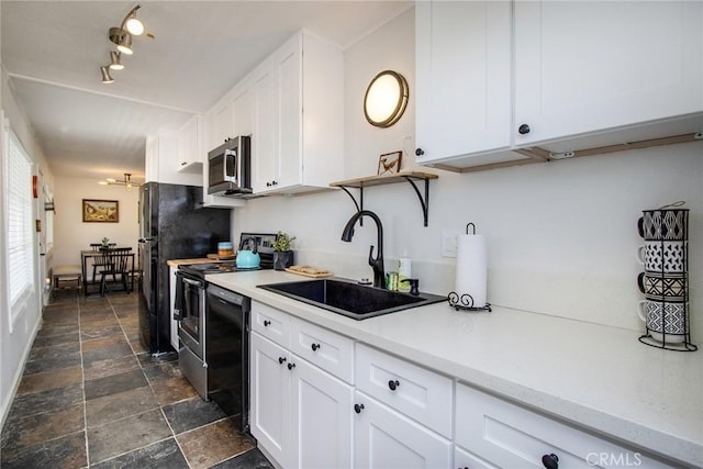4574 Avenida Del Sol, Joshua Tree, CA 92252 - kitchen featuring black appliances, dark stone finish floors, light countertops, and white cabinetry