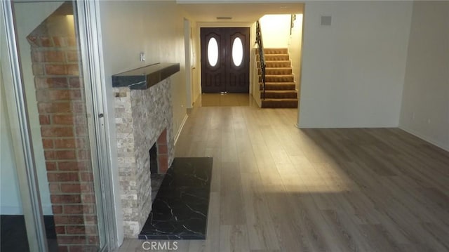 708 N Montebello Blvd, Montebello, CA 90640 - foyer featuring light wood-style flooring, stairway, and a fireplace