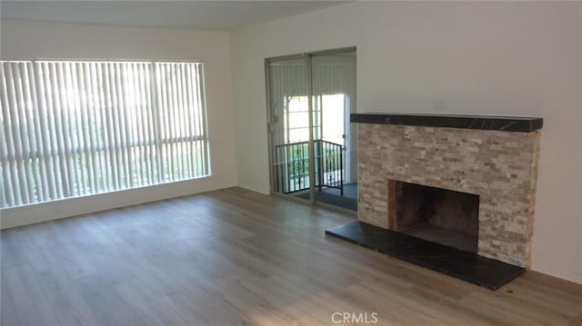 708 N Montebello Blvd, Montebello, CA 90640 - unfurnished living room featuring wood finished floors and a fireplace with raised hearth