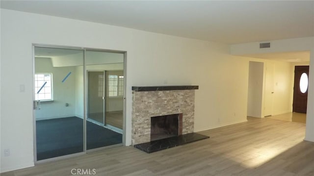 708 N Montebello Blvd, Montebello, CA 90640 - unfurnished living room featuring wood finished floors and a stone fireplace