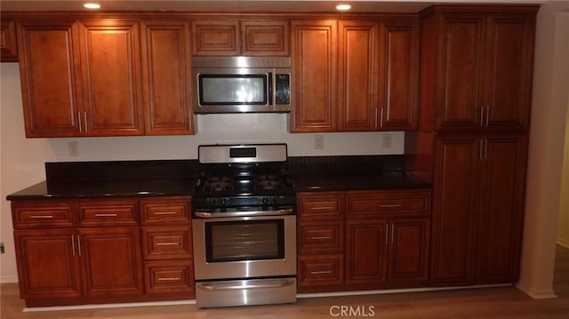 708 N Montebello Blvd, Montebello, CA 90640 - kitchen with appliances with stainless steel finishes, recessed lighting, brown cabinetry, and light wood-style flooring
