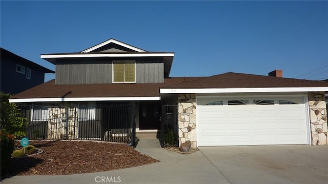 708 N Montebello Blvd, Montebello, CA 90640 - view of front of property featuring stone siding, driveway, a garage, and a chimney