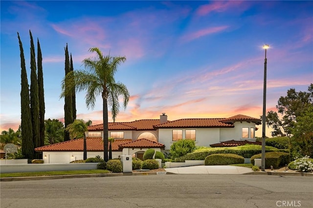 30833 La Solana Ct, Redlands, CA 92373 - mediterranean / spanish-style home featuring a tile roof, a chimney, stucco siding, an attached garage, and driveway
