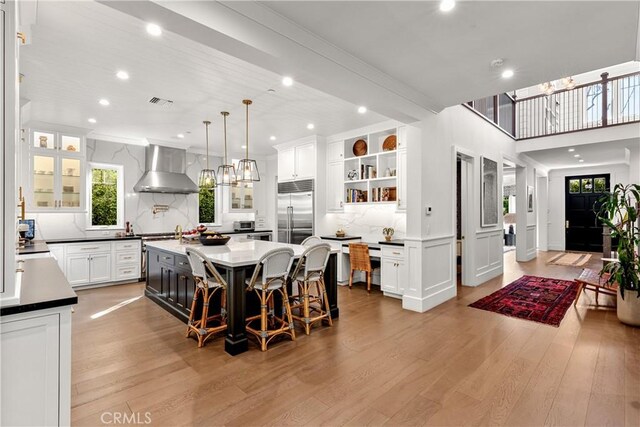 4164 Sunnyslope Ave, Sherman Oaks, CA 91423 - kitchen with wall chimney exhaust hood, built in fridge, open shelves, recessed lighting, and light wood-style floors