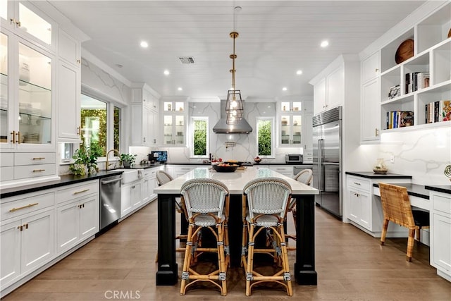 4164 Sunnyslope Ave, Sherman Oaks, CA 91423 - kitchen featuring appliances with stainless steel finishes, wall chimney exhaust hood, recessed lighting, and white cabinetry