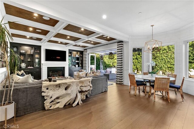 4164 Sunnyslope Ave, Sherman Oaks, CA 91423 - living room featuring a chandelier, hardwood / wood-style flooring, coffered ceiling, beamed ceiling, and a glass covered fireplace