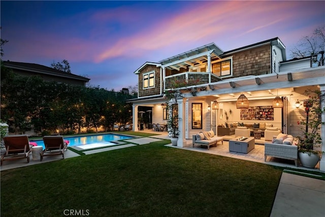 4164 Sunnyslope Ave, Sherman Oaks, CA 91423 - back of property at dusk featuring outdoor lounge area, a balcony, a patio area, and a lawn