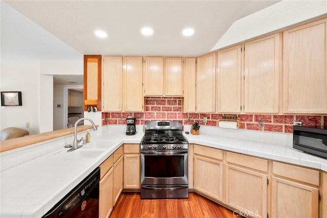 29678 Deal Ct, Temecula, CA 92591 - kitchen with gas range, light brown cabinetry, black dishwasher, tile countertops, and recessed lighting