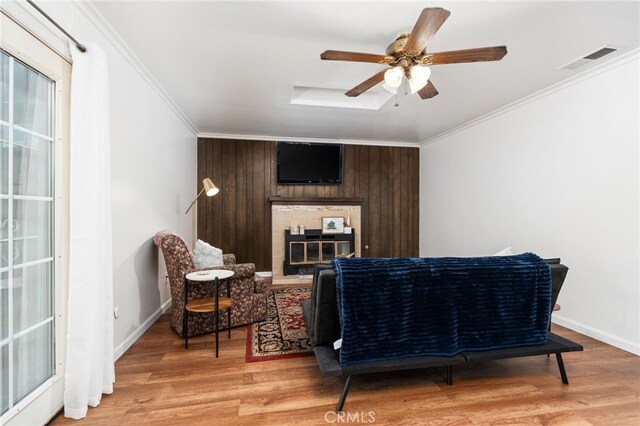 3367 M St, Merced, CA 95348 - sitting room featuring light wood finished floors, crown molding, a glass covered fireplace, and a ceiling fan