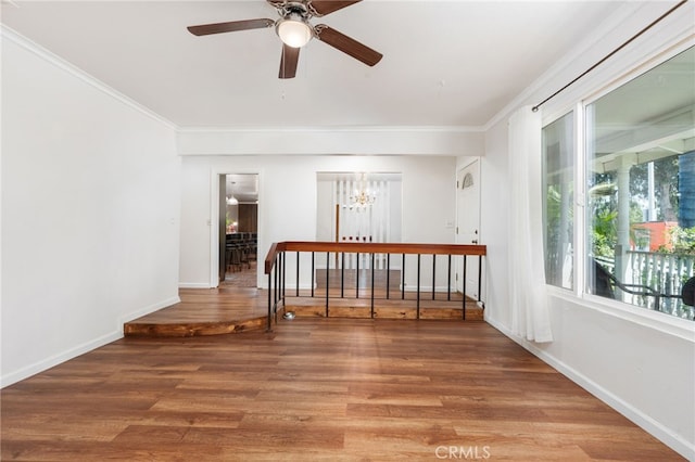 3367 M St, Merced, CA 95348 - empty room featuring ceiling fan, a chandelier, ornamental molding, plenty of natural light, and light wood-style flooring