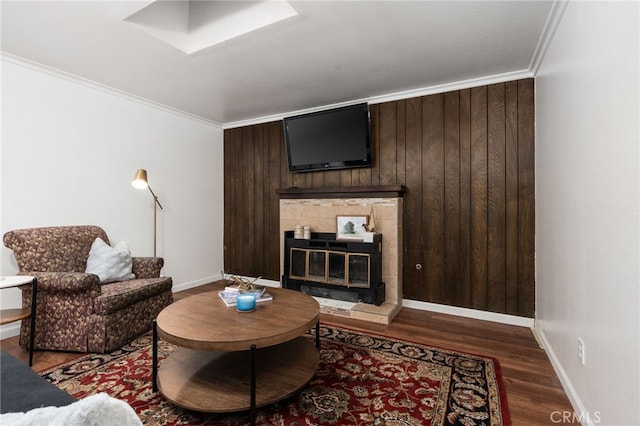 3367 M St, Merced, CA 95348 - living room with wood finished floors, ornamental molding, a fireplace, and wooden walls