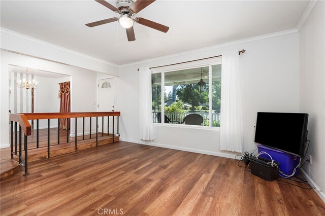 3367 M St, Merced, CA 95348 - unfurnished living room with ornamental molding, wood finished floors, a chandelier, and ceiling fan