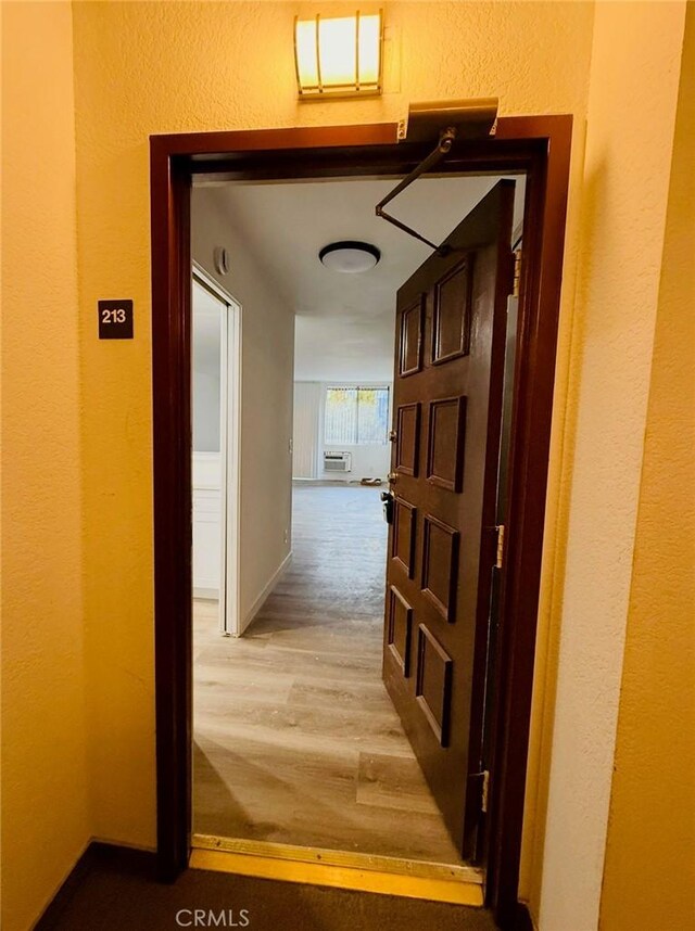 4170 Elm Ave Unit 213, Long Beach, CA 90807 - corridor with light wood finished floors and a textured wall