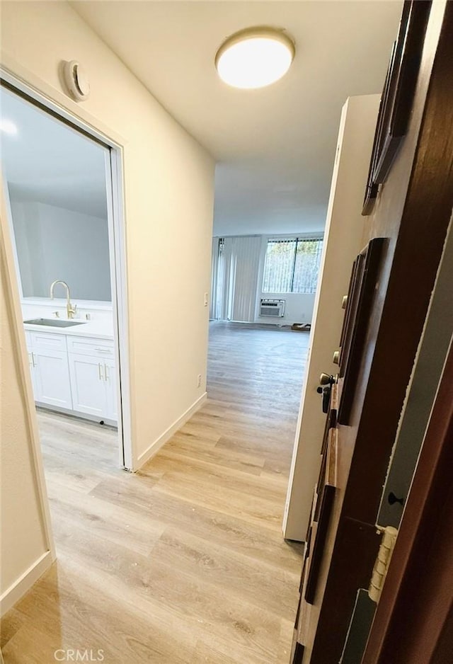4170 Elm Ave Unit 213, Long Beach, CA 90807 - corridor with light wood finished floors and a wall mounted air conditioner