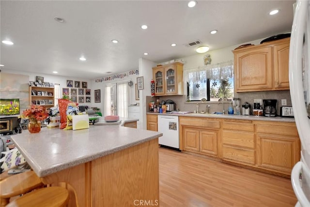 23201 Cardinal Rd, Wrightwood, CA 92397 - kitchen with dishwasher, light countertops, recessed lighting, backsplash, and a kitchen bar