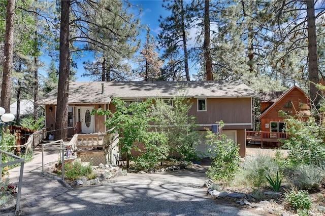 23201 Cardinal Rd, Wrightwood, CA 92397 - view of front of house with asphalt driveway, an attached garage, and a porch