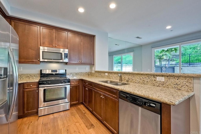 6925 Tourmaline, Carlsbad, CA 92009 - kitchen with appliances with stainless steel finishes, light wood finished floors, a peninsula, recessed lighting, and light stone counters