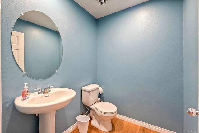 6925 Tourmaline, Carlsbad, CA 92009 - half bath featuring wood finished floors and toilet