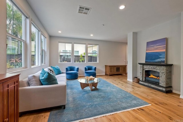 6925 Tourmaline, Carlsbad, CA 92009 - living area featuring healthy amount of natural light, light wood-style floors, recessed lighting, and a fireplace