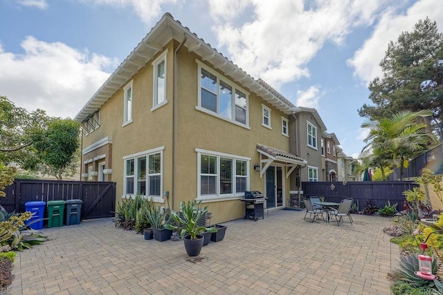 6925 Tourmaline, Carlsbad, CA 92009 - back of property with stucco siding, a patio, and a fenced backyard