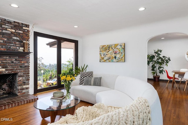 405 Sequoia Dr, Pasadena, CA 91105 - living area with arched walkways, recessed lighting, wood finished floors, and a brick fireplace