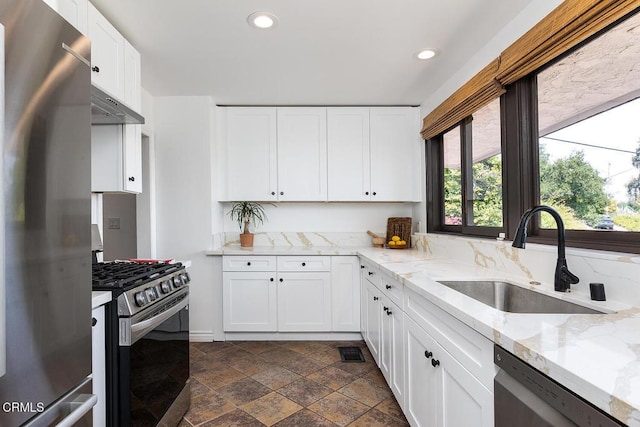 405 Sequoia Dr, Pasadena, CA 91105 - kitchen with stainless steel appliances, dark stone finish flooring, recessed lighting, white cabinets, and extractor fan