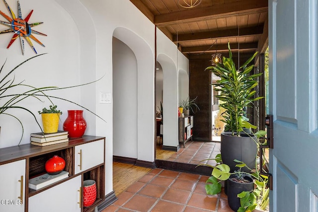 405 Sequoia Dr, Pasadena, CA 91105 - foyer entrance with a wooden ceiling with exposed beams, arched walkways, and dark tile patterned floors