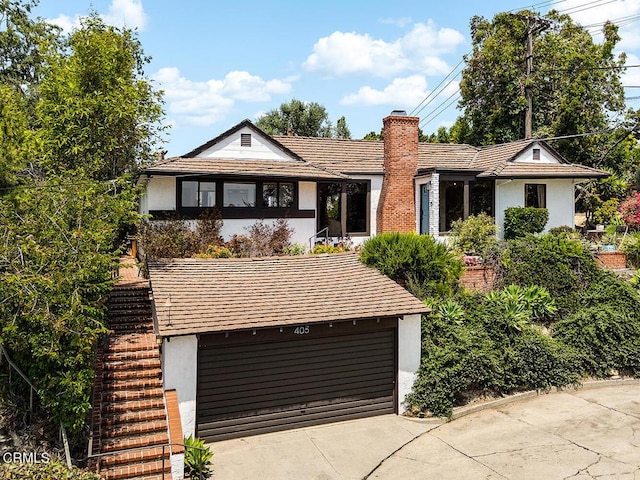 405 Sequoia Dr, Pasadena, CA 91105 - view of front facade featuring a chimney, stucco siding, a garage, and driveway
