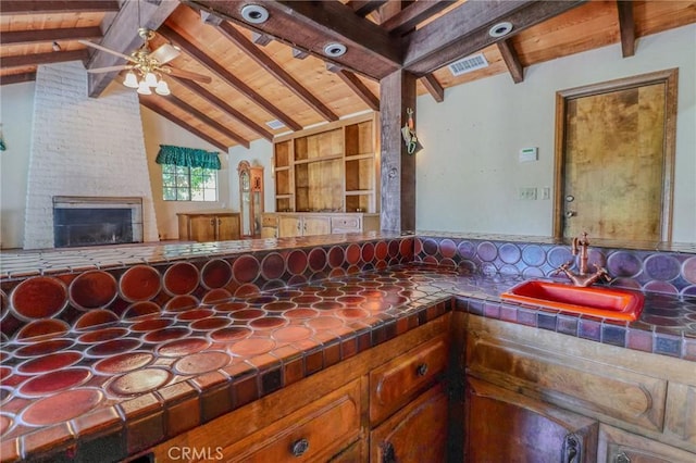 2033 Benbow Pl, Riverside, CA 92506 - kitchen featuring tile counters, a ceiling fan, and a fireplace