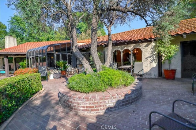 2033 Benbow Pl, Riverside, CA 92506 - rear view of property with a tiled roof, stucco siding, a chimney, and a patio area