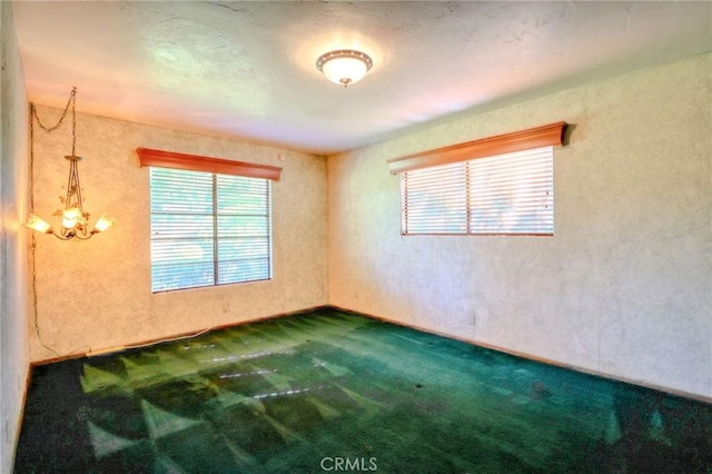 2033 Benbow Pl, Riverside, CA 92506 - unfurnished room featuring carpet flooring, healthy amount of natural light, a textured wall, and a chandelier