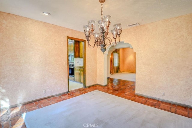2033 Benbow Pl, Riverside, CA 92506 - spare room with arched walkways and a chandelier