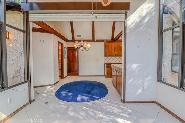 2033 Benbow Pl, Riverside, CA 92506 - kitchen with brown cabinetry, a chandelier, light tile patterned floors, backsplash, and light countertops
