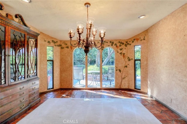2033 Benbow Pl, Riverside, CA 92506 - unfurnished dining area with healthy amount of natural light, a chandelier, and tile patterned floors