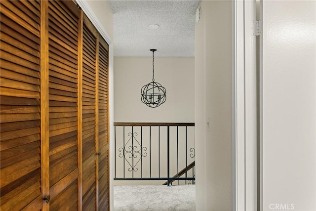 14000 Cerise Ave, Hawthorne, CA 90250 - hallway with a textured ceiling, carpet, and a chandelier