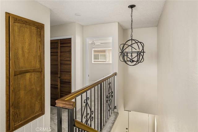 14000 Cerise Ave, Hawthorne, CA 90250 - corridor with an upstairs landing, carpet flooring, a chandelier, and a textured ceiling