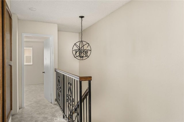 14000 Cerise Ave, Hawthorne, CA 90250 - corridor featuring an upstairs landing, light carpet, a chandelier, and a textured ceiling