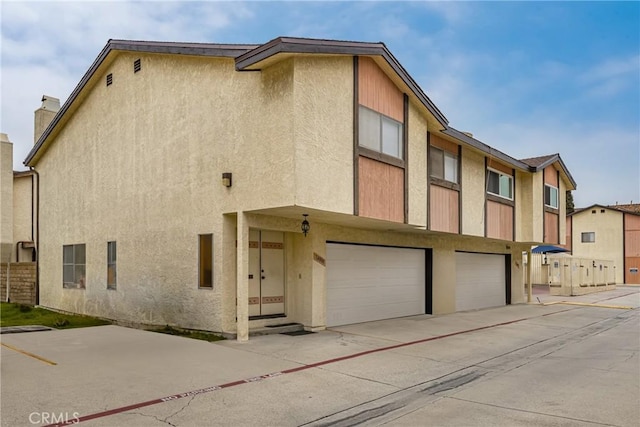 14000 Cerise Ave, Hawthorne, CA 90250 - view of front facade with an attached garage, stucco siding, and concrete driveway