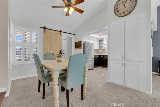 801 Vine St, Exeter, CA 93221 - dining room featuring a barn door, light carpet, ceiling fan, and vaulted ceiling
