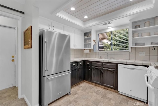 801 Vine St, Exeter, CA 93221 - kitchen featuring freestanding refrigerator, open shelves, white dishwasher, stone finish flooring, and a tray ceiling