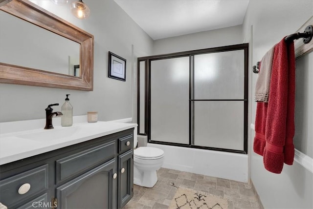 801 Vine St, Exeter, CA 93221 - bathroom featuring vanity, combined bath / shower with glass door, and stone finish flooring