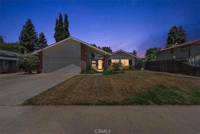 801 Vine St, Exeter, CA 93221 - view of front facade featuring an attached garage, driveway, and brick siding