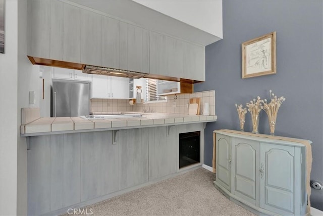 801 Vine St, Exeter, CA 93221 - kitchen with stainless steel fridge, tile counters, tasteful backsplash, carpet floors, and a breakfast bar