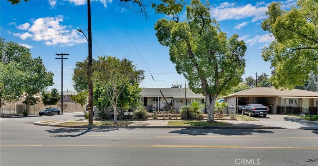 1702 N Sierra Way, San Bernardino, CA 92405 - view of front of house featuring driveway and an attached carport