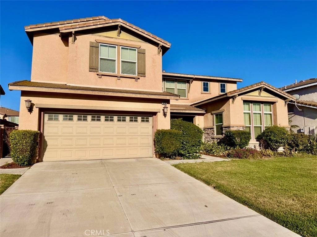 6650 Ashford Mill Ct, Eastvale, CA 92880 - traditional-style home with stucco siding, driveway, a garage, and a front lawn